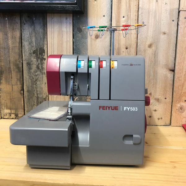 FEIYUE Overlocker machine on a wooden surface