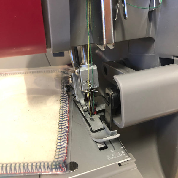 Close-up of a overlocker machine needle and mechanism