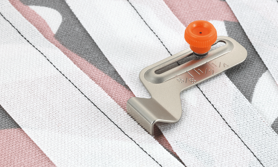 Brother SG1 seam guide with orange adjustment screw and engraved seam allowances